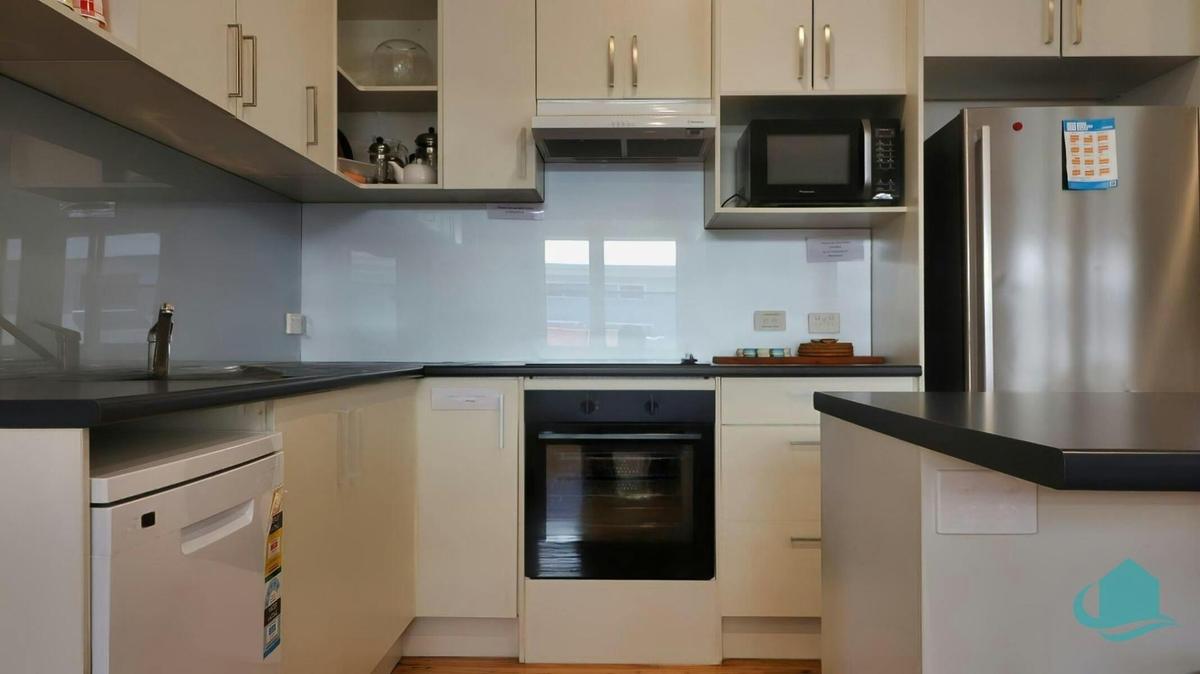 Kitchen with dishwasher and under bench oven