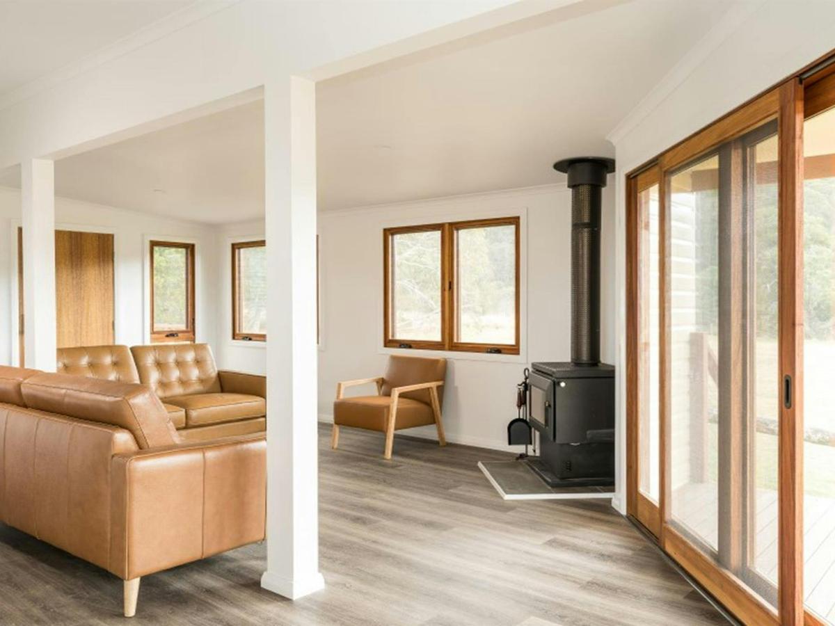 The living room with fireplace at Mooraback Cabin in Werrikimbe National Park. Photo: David Waugh
