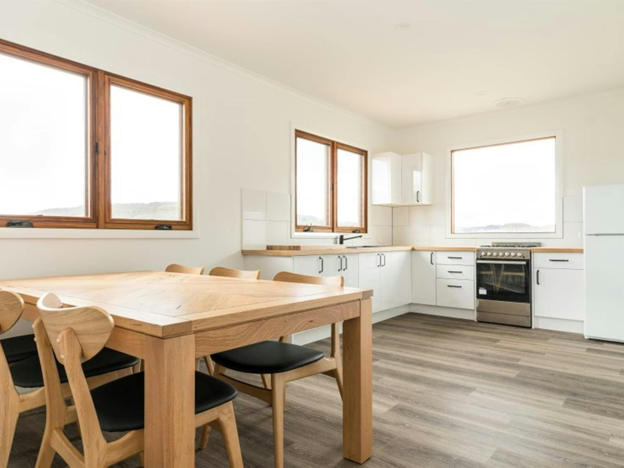 The dining table and kitchen in Mooraback Cabin, Werrikimbe National Park. Photo: David Waugh &copy;