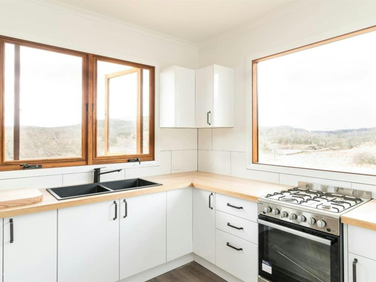 The kitchen at Mooraback Cabin looking out towards Werrikimbe National Park. Photo: David Waugh