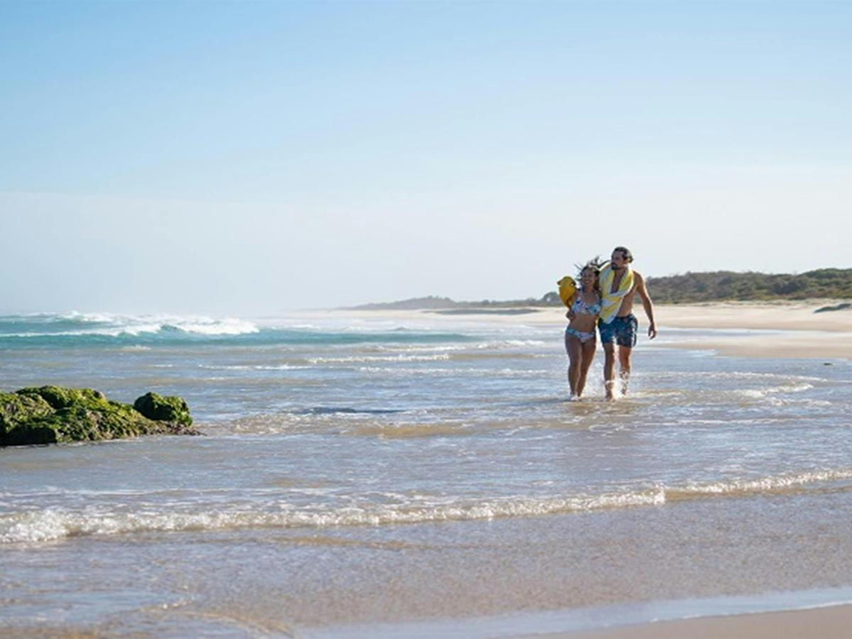 A couple enjoying the beach near Kylies Beach campground, Crowdy Bay National Park. Photo: Rob