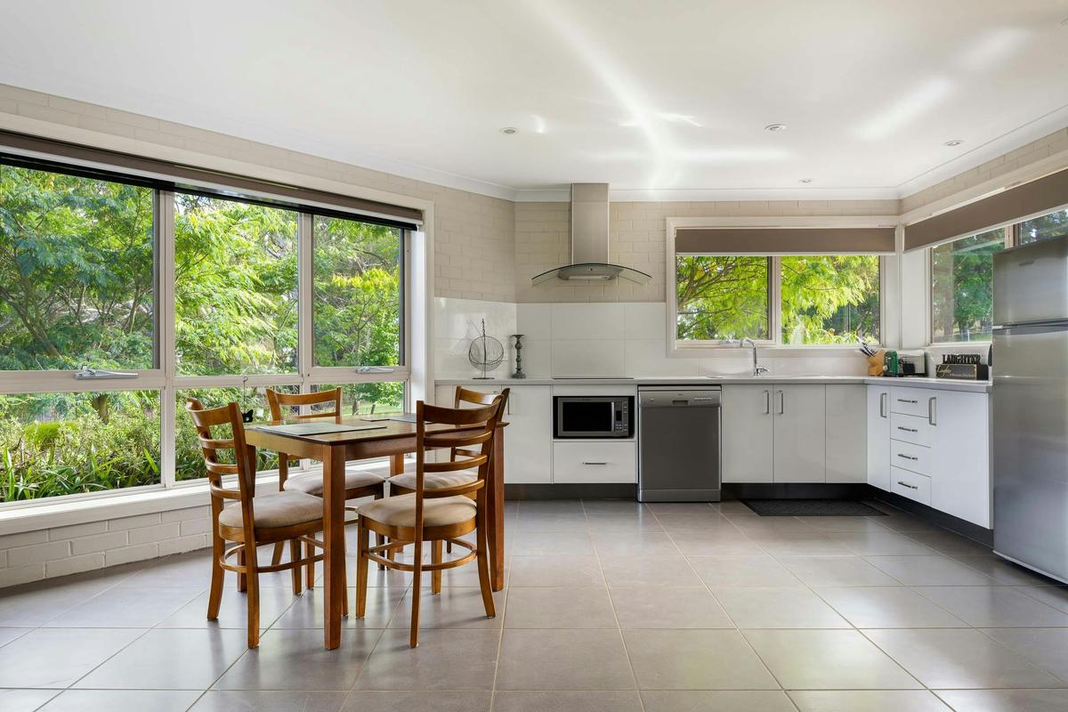 Dining and kitchen with large windows to garden