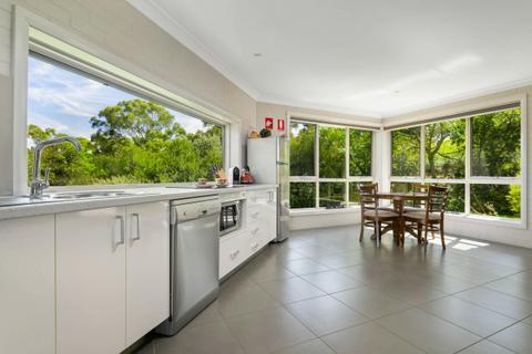 Kitchen and dining area - showing dishwasher, microwave, cook top and 4 seats for dining big windows