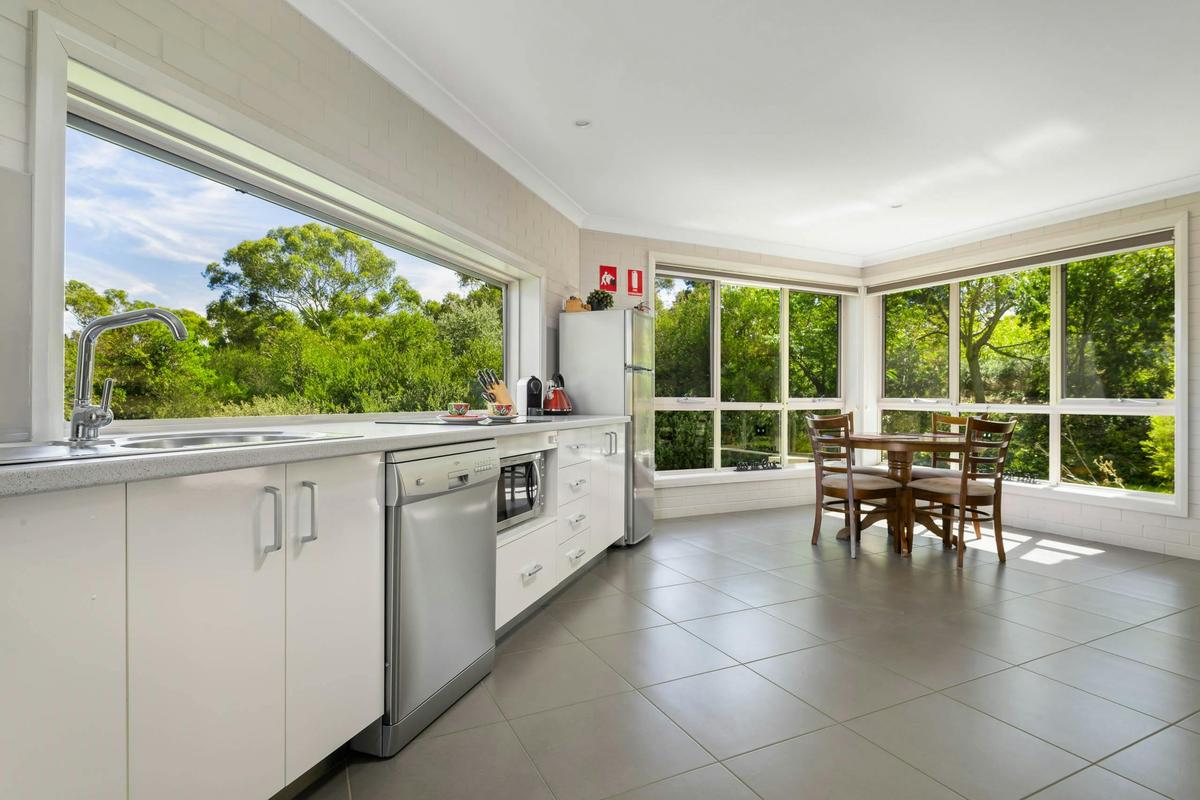Kitchen and dining area - showing dishwasher, microwave, cook top and 4 seats for dining big windows