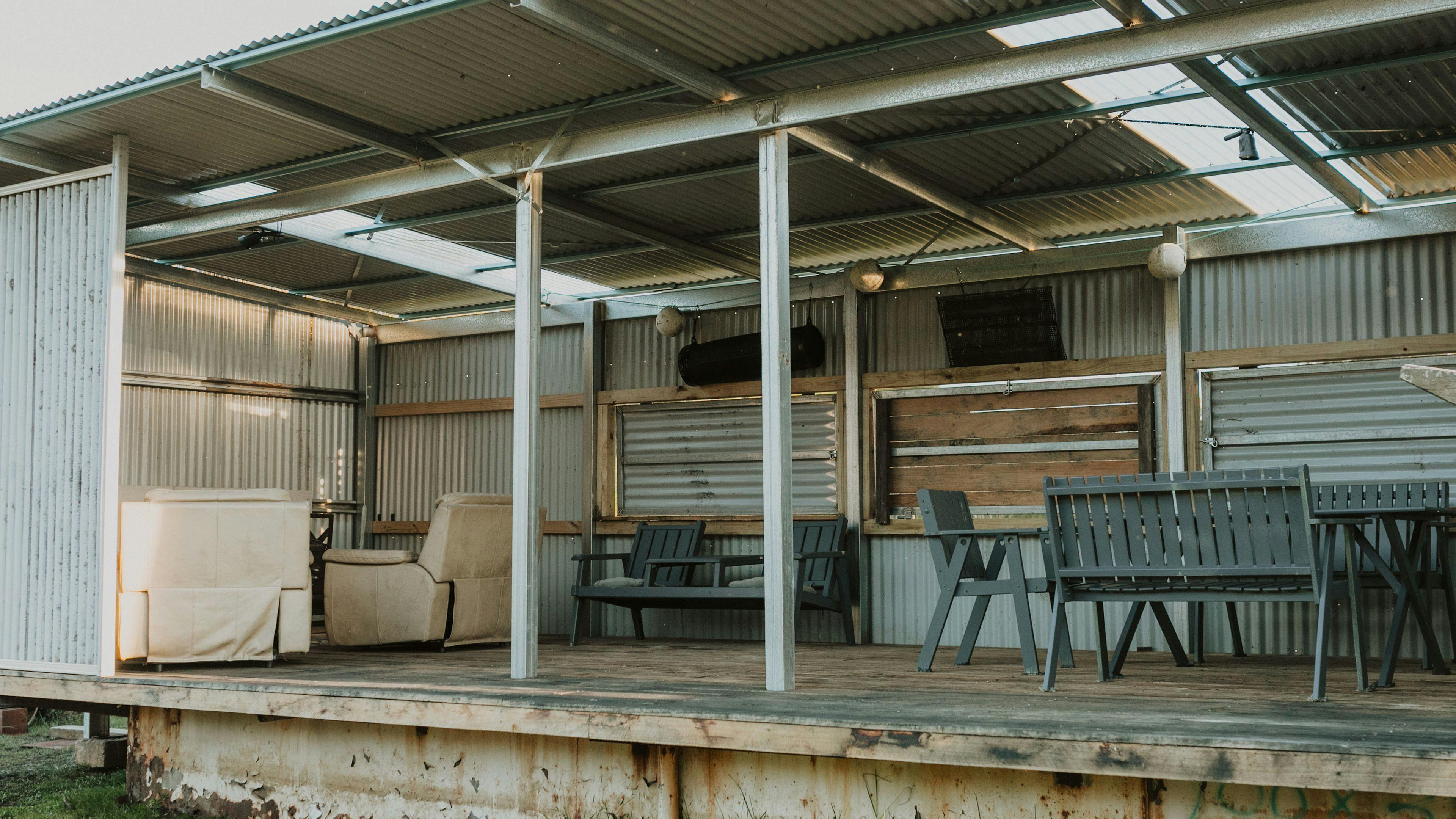 The shed where you can relax, sit around the table, enjoy a fire, play some darts...