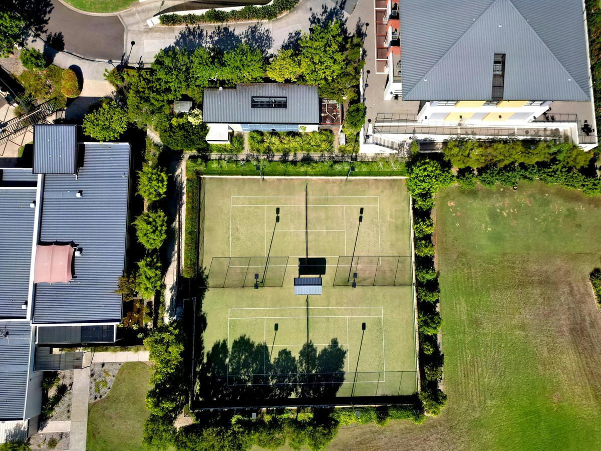 mercure kooindah waters ariel view showing tennis courts and property