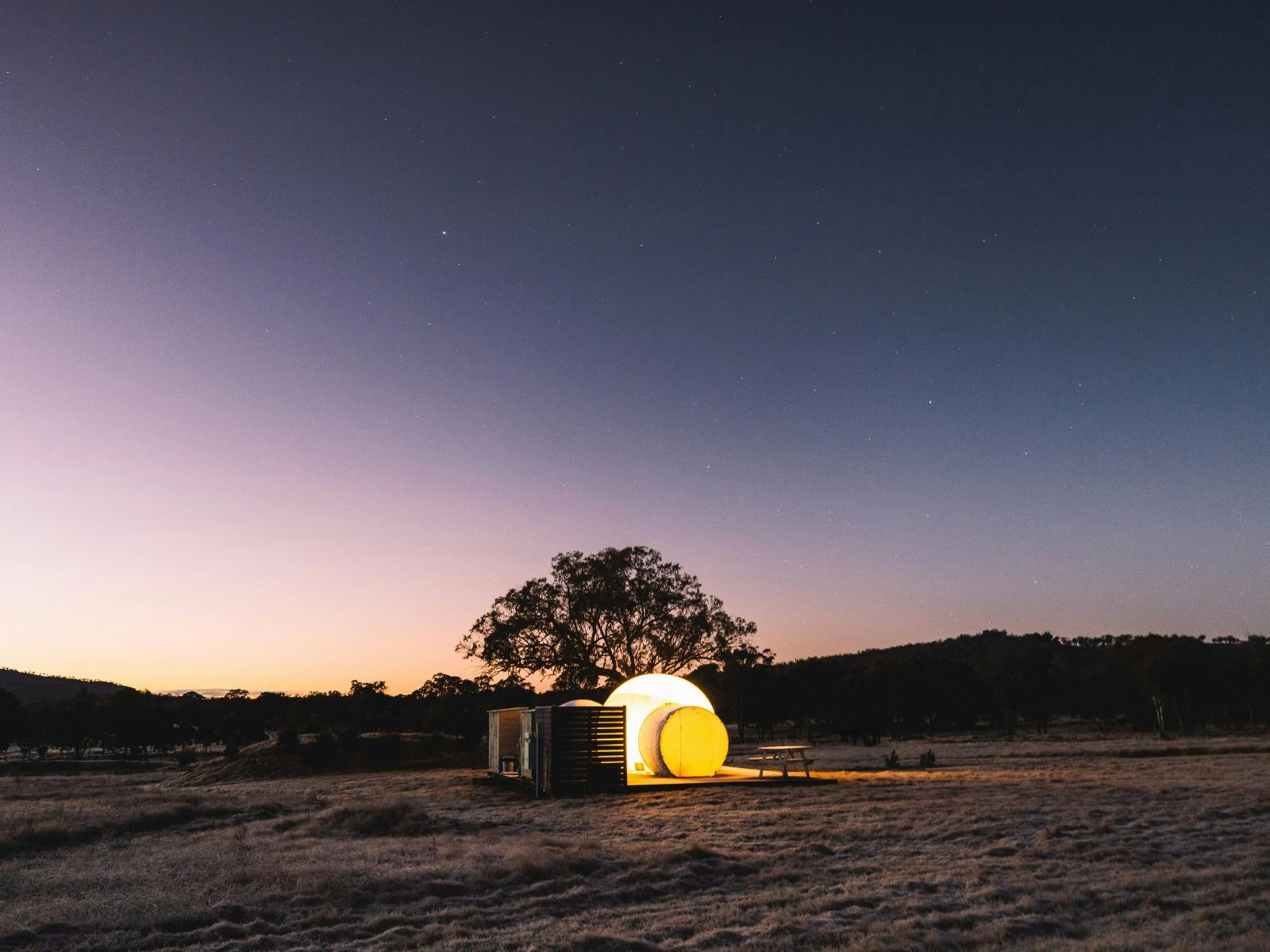 Captain Moonlite at sunrise — stars fading, sky blushing pink in the first light