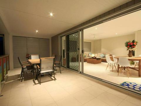 Balcony with dining setting looking into spacious open plan living and dining room