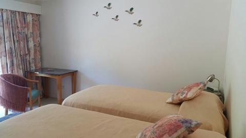 Super comfortable twin king single beds with table, tub chairs and external access