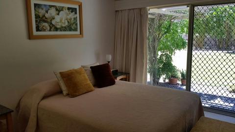 Super comfortable queen size bed in spacious room with exterior access to covered pergola area