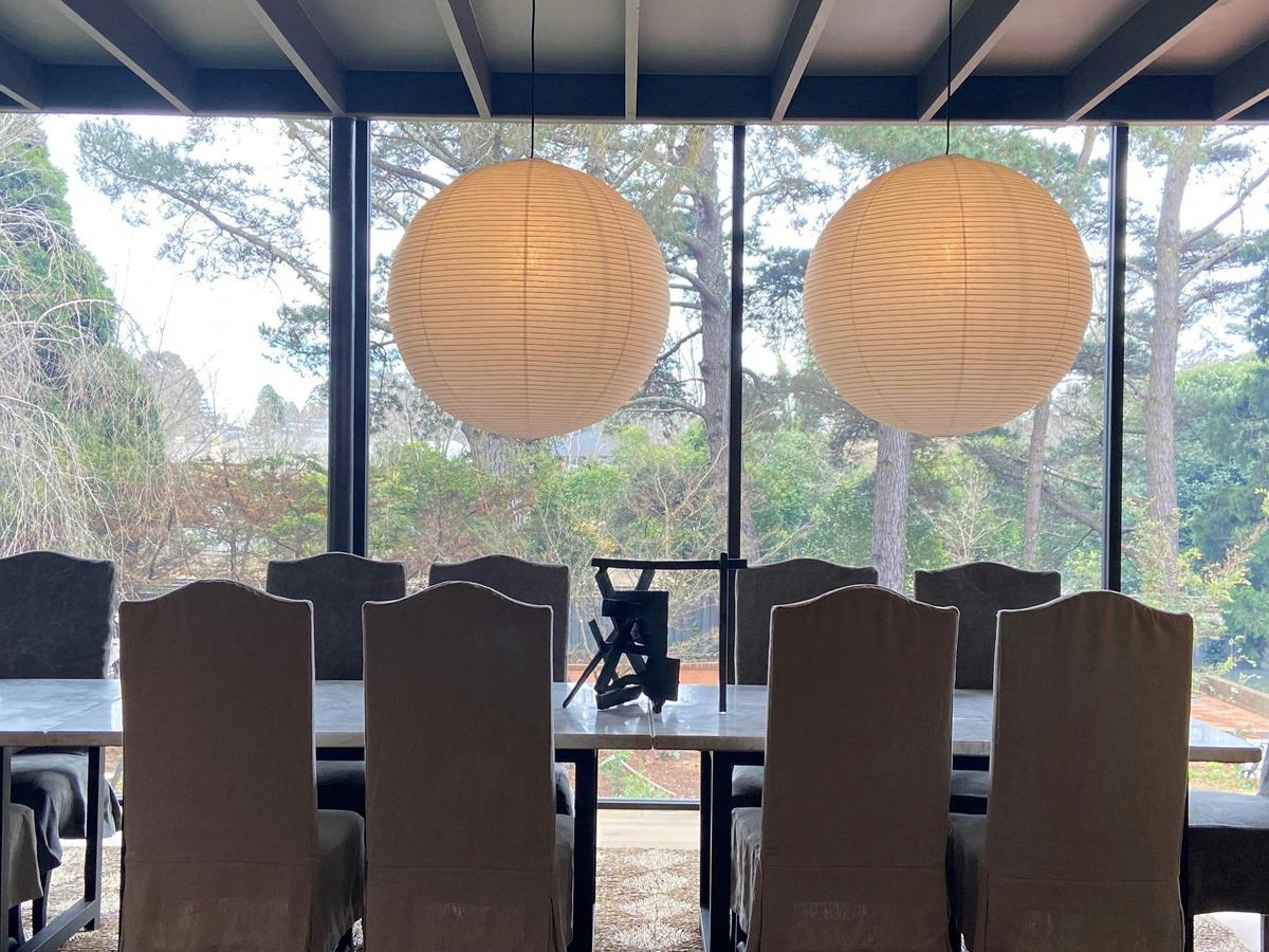 Stunning dining room in a modern glass pavilion.