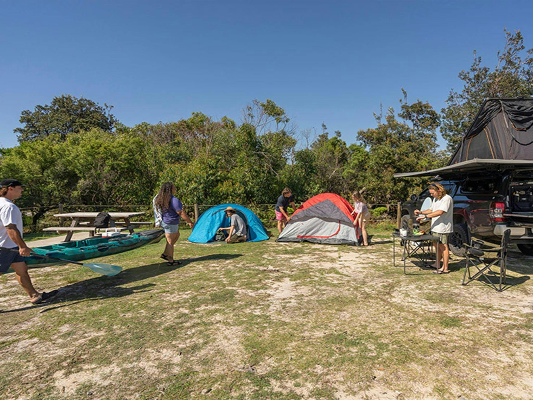 Campers heading off with their kayak at Mibanbah-Black Rocks campground. Credit: John Spencer &copy;