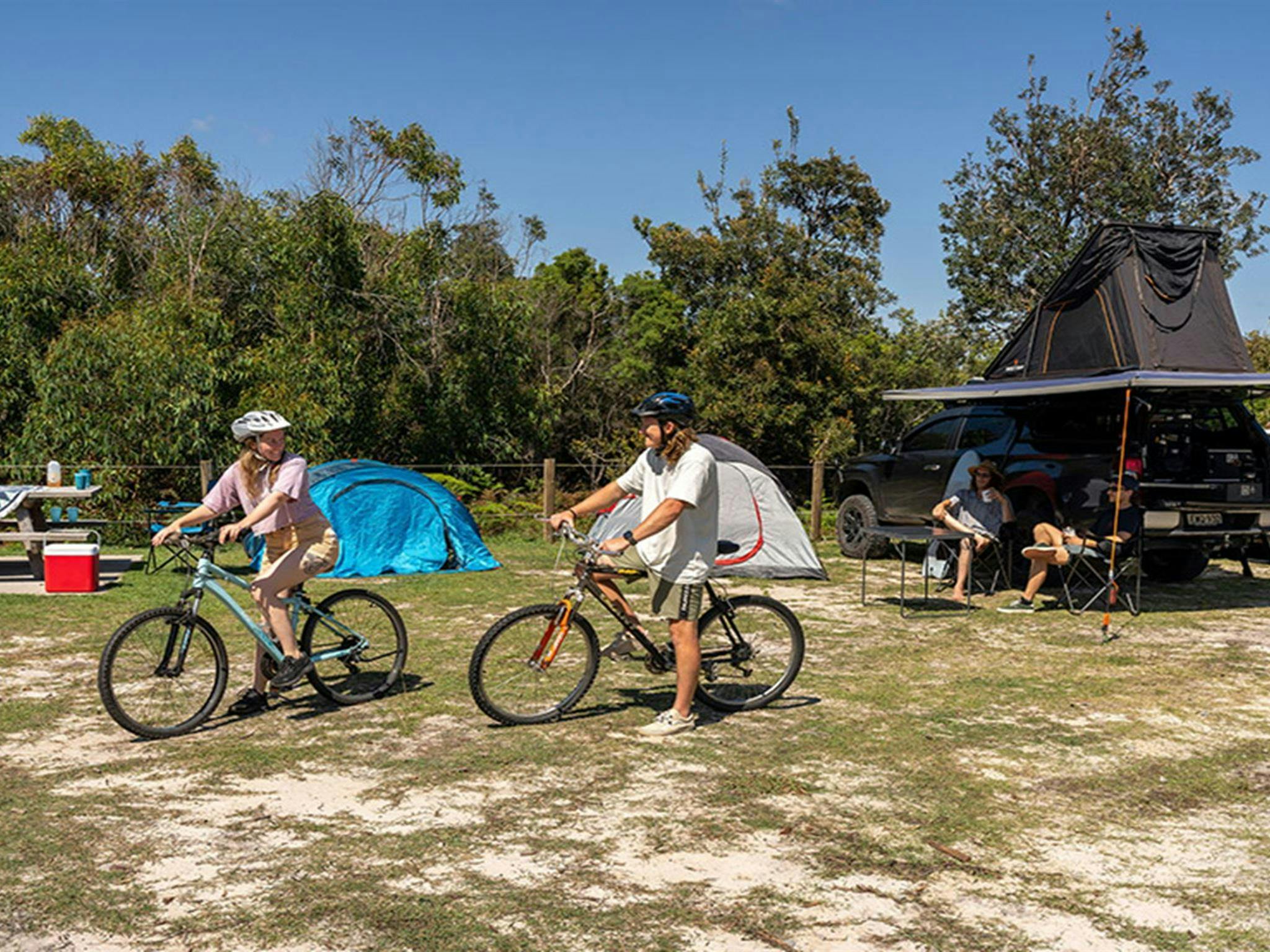 Campers heading off on their bikes at Mibanbah-Black Rocks campground. Credit: John Spencer &copy;