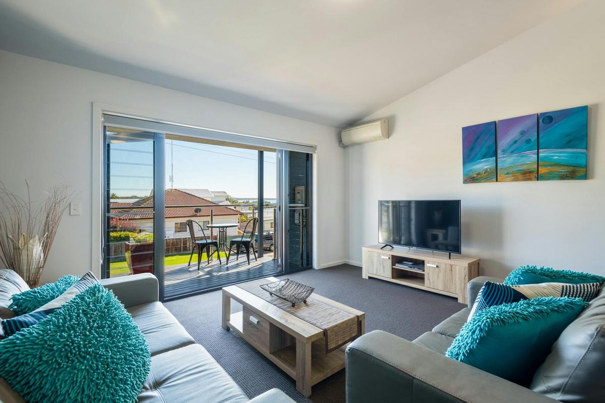 Lounge opening up onto north facing balcony with water views