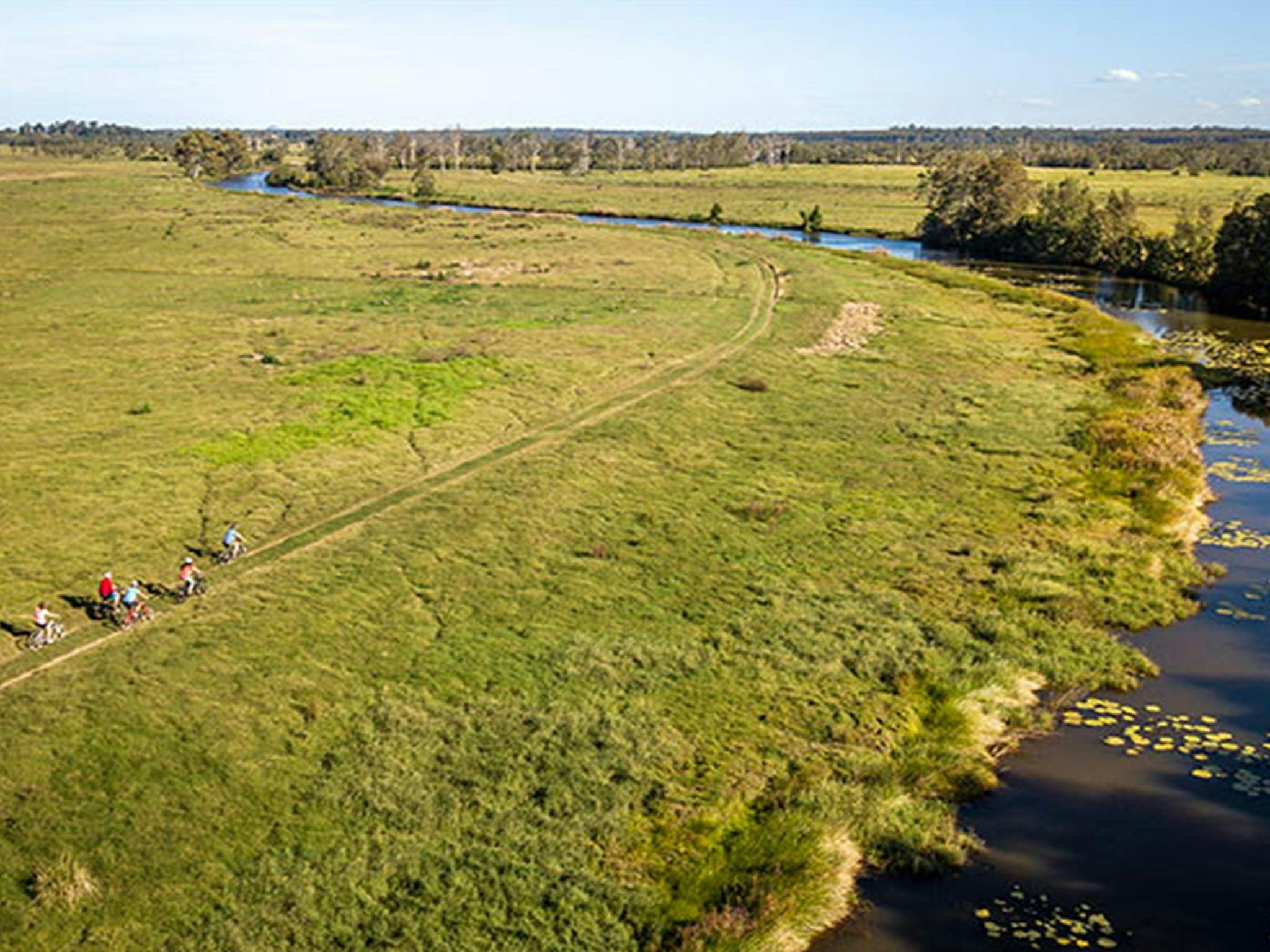 A group cycling along Woody Creek in Everlasting Swamp National Park. Photo: John Spencer/OEH
