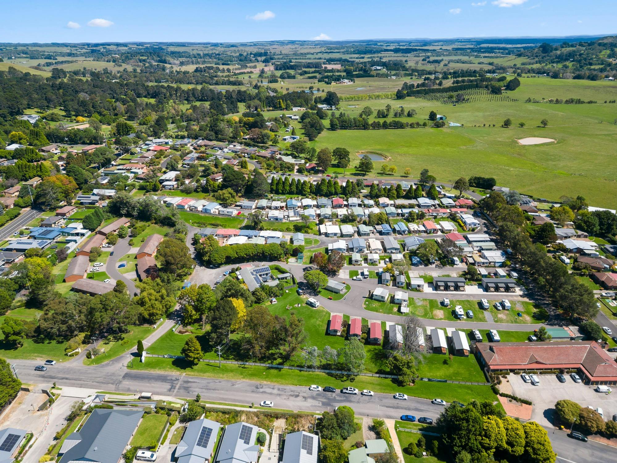 Aerial view of the Park showcasing a well-organized layout of cabins, homes & green space.