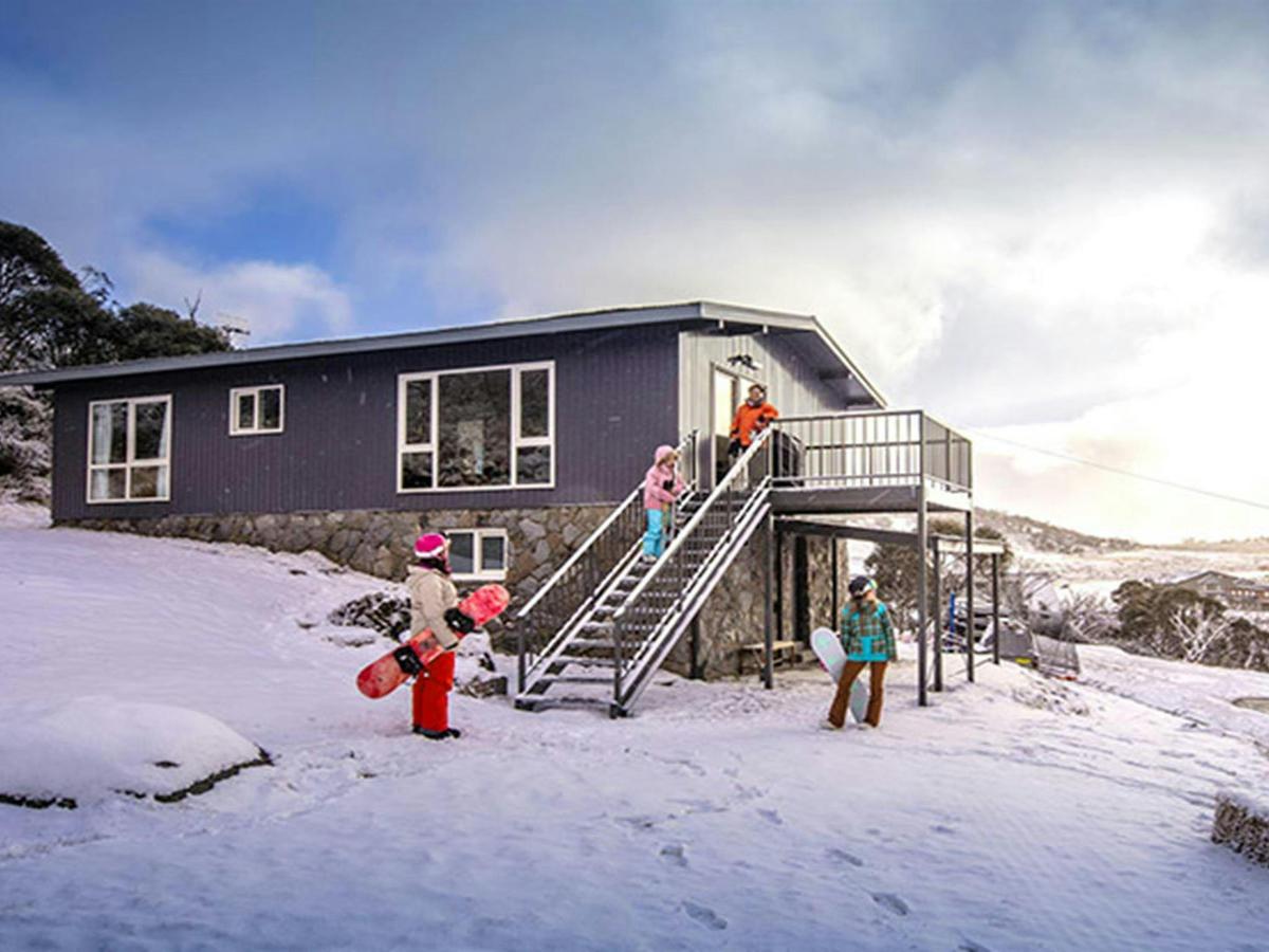 A family in the snow outside Numbananga Lodge, Kosciuszko National Park. Photo: Murray