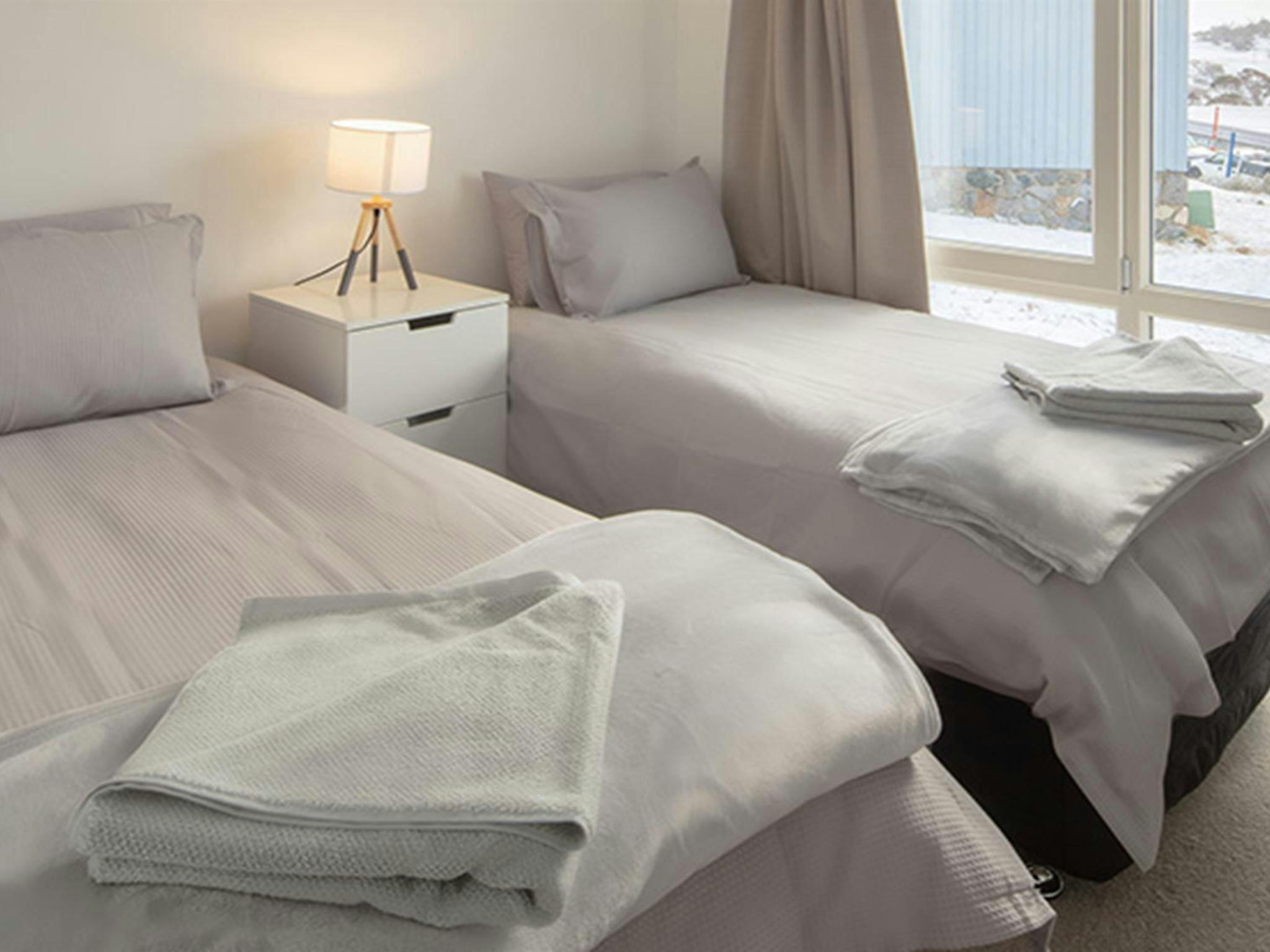 Twin beds in room at Numbananga Lodge, Kosciuszko National Park. Photo: Murray Vanderveer/OEH