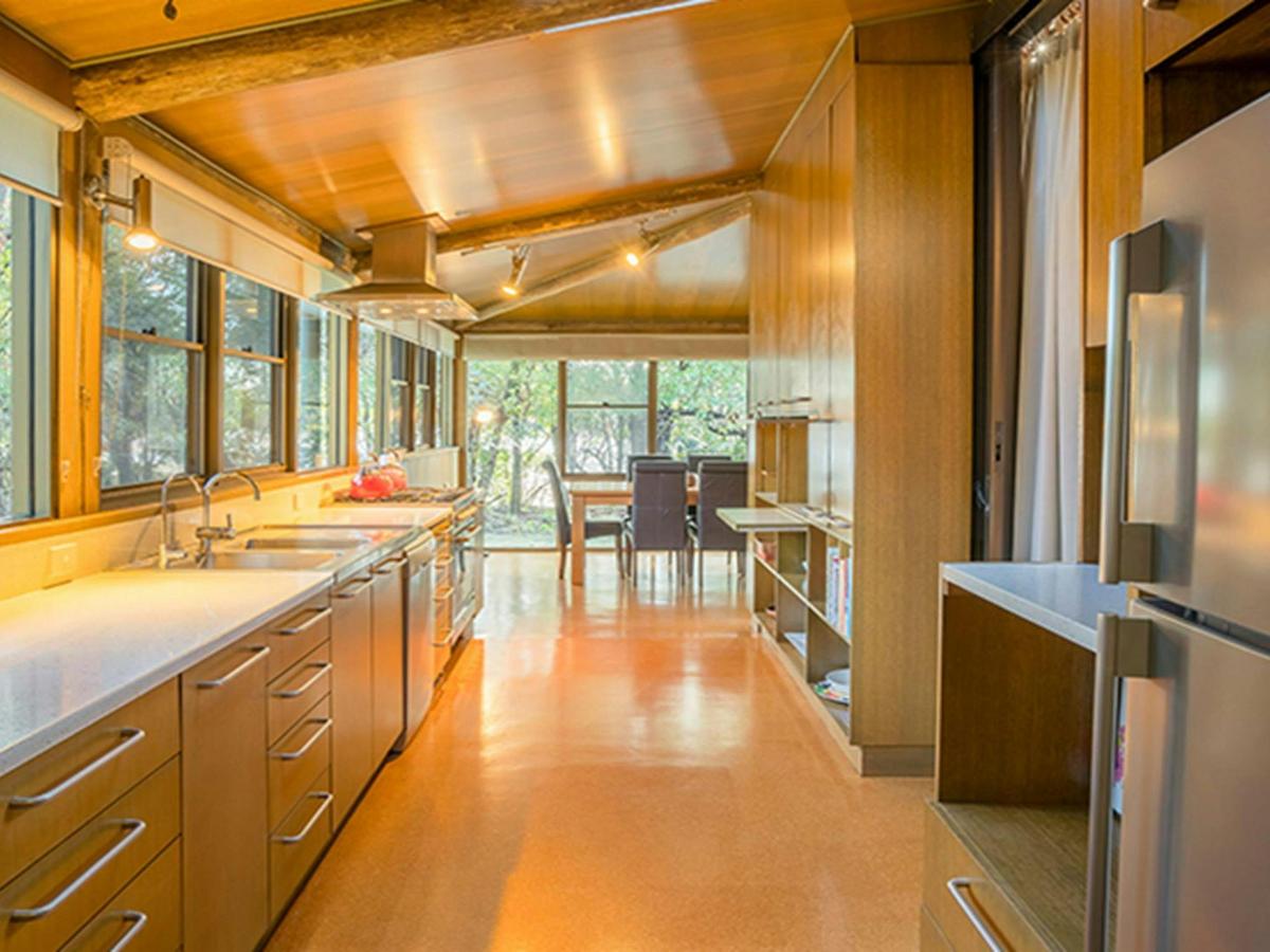 Photo of the long kitchen and dining table at Myer House. Photo: OEH/John Spencer