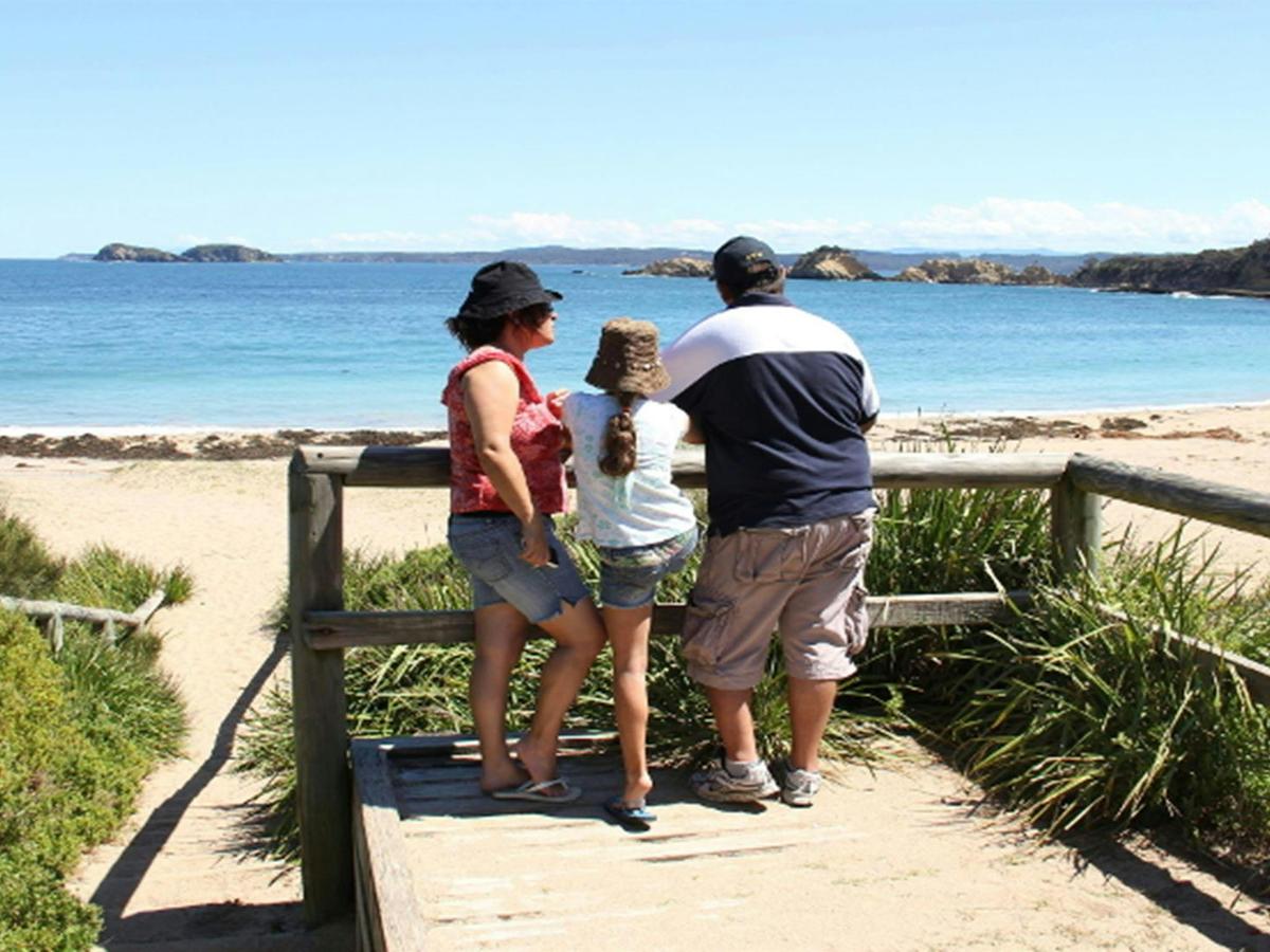 Family at a lookout over North Head Beach in Murramarang National Park. Photo: John Yurasek/DPIE