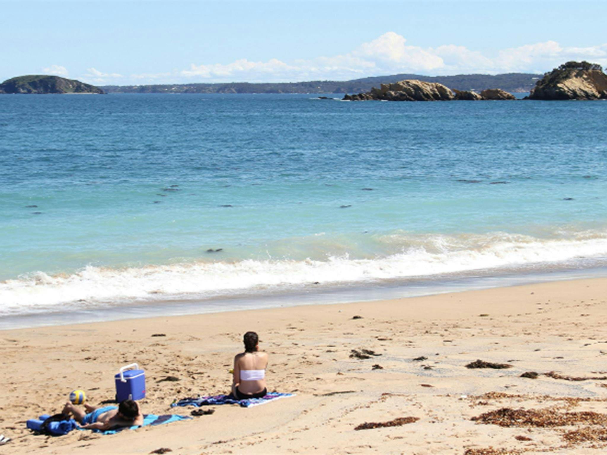 Two swimmers resting on North Head Beach in Murramarang National Park. Photo: John Yurasek/DPIE