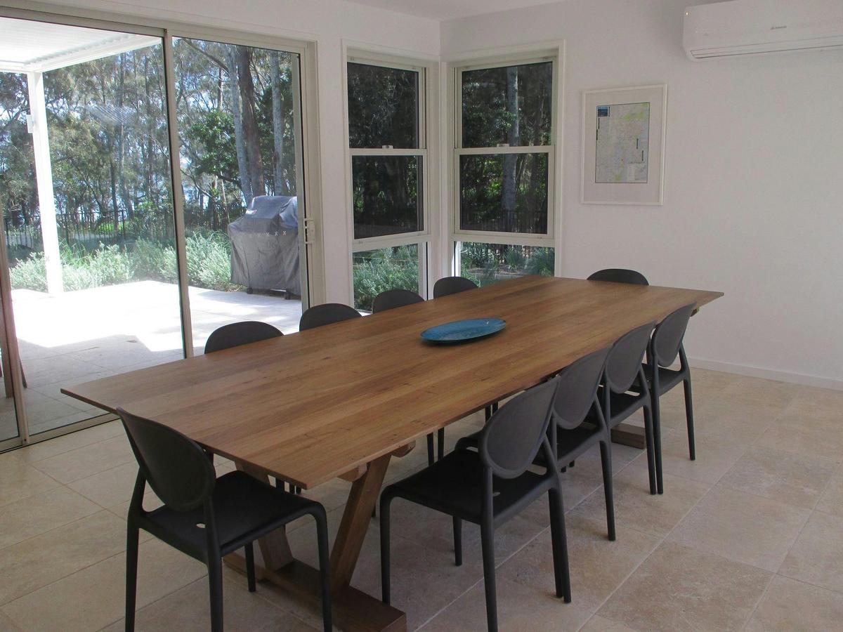 Large dining table situated off the gourmet kitchen area