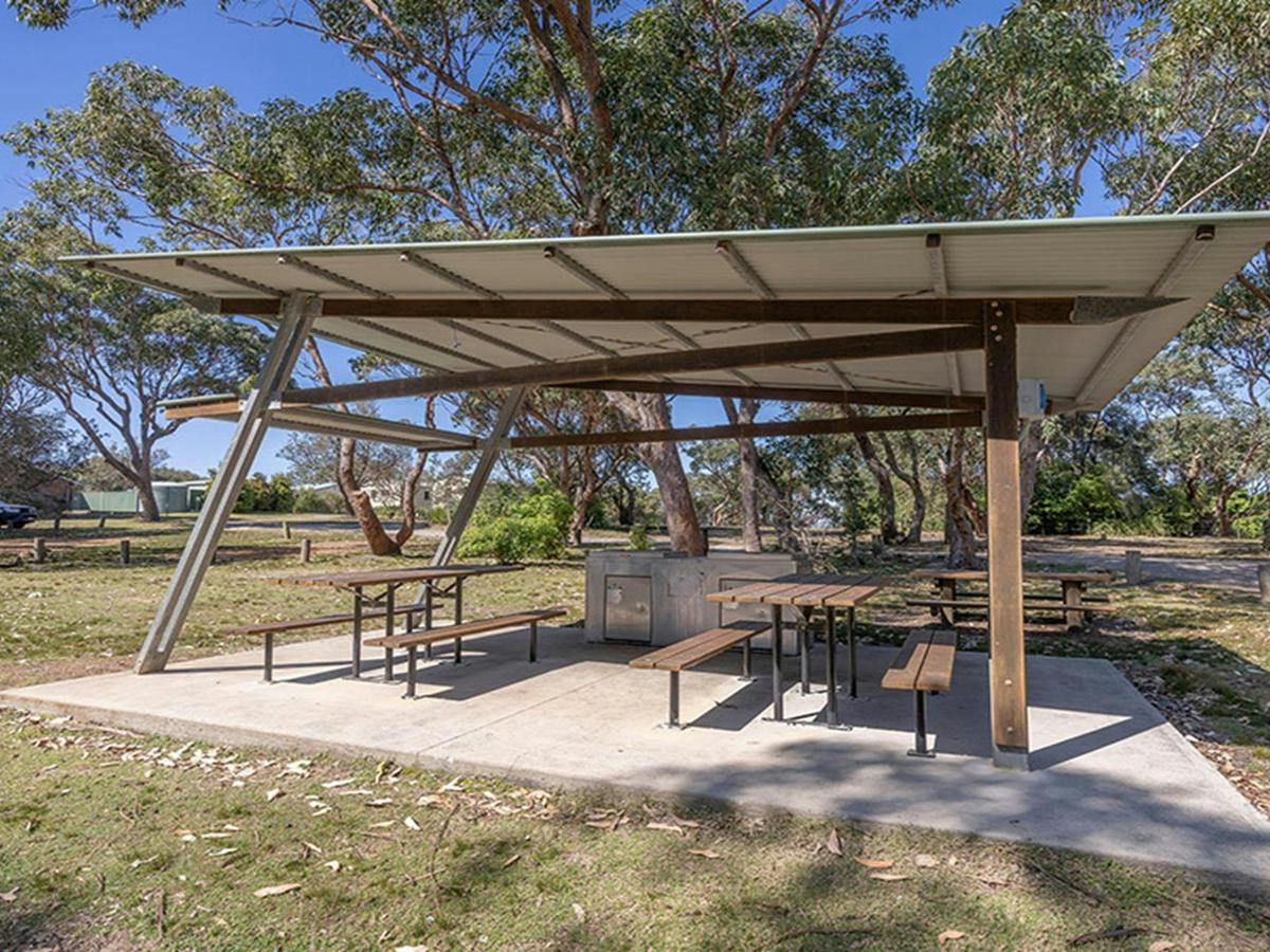 Picnic shelter with barbecues at Pretty Beach campground. Credit: John Spencer &copy; DCCEEW