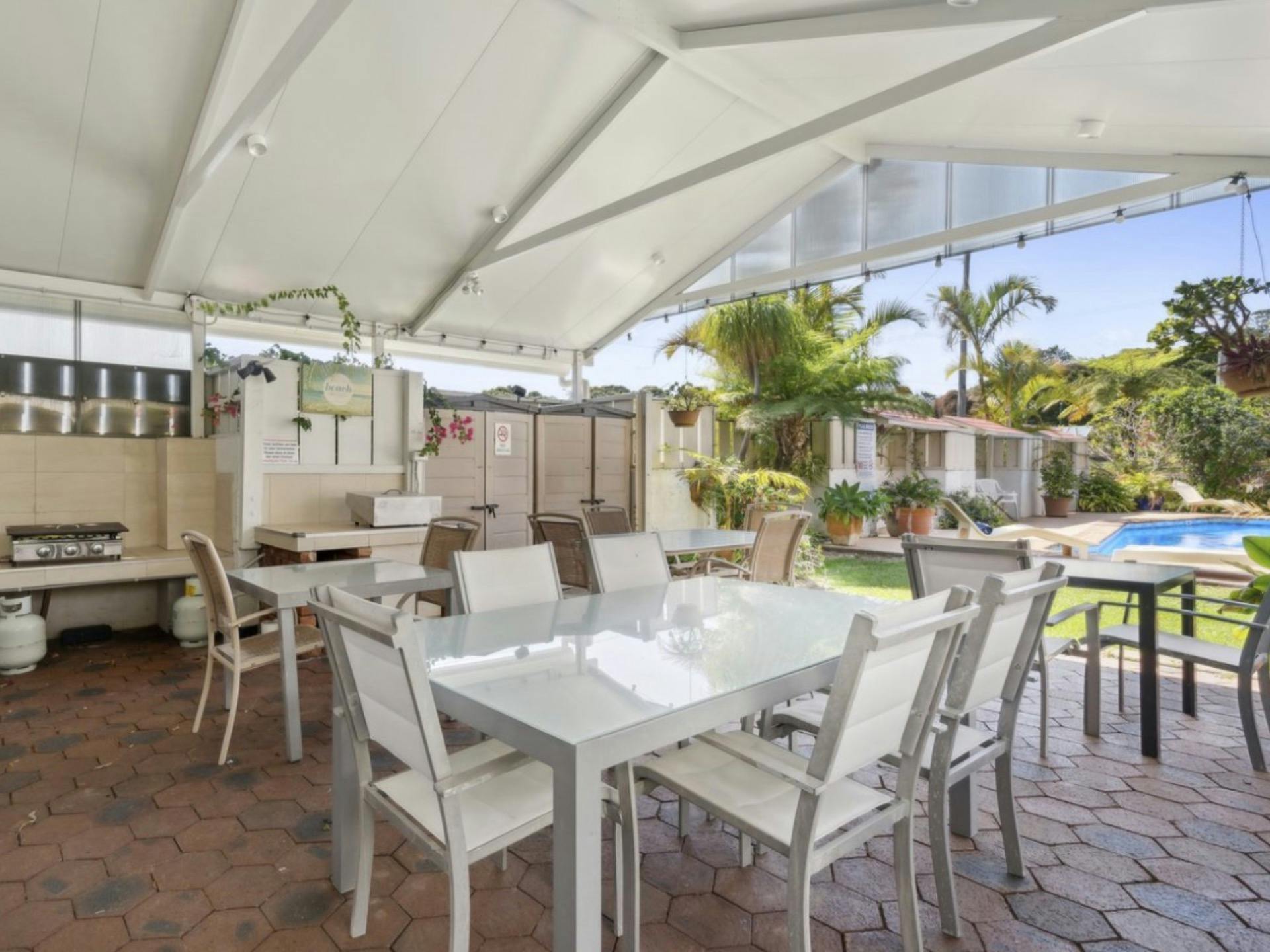 BBQ area and outdoor dining beside the pool