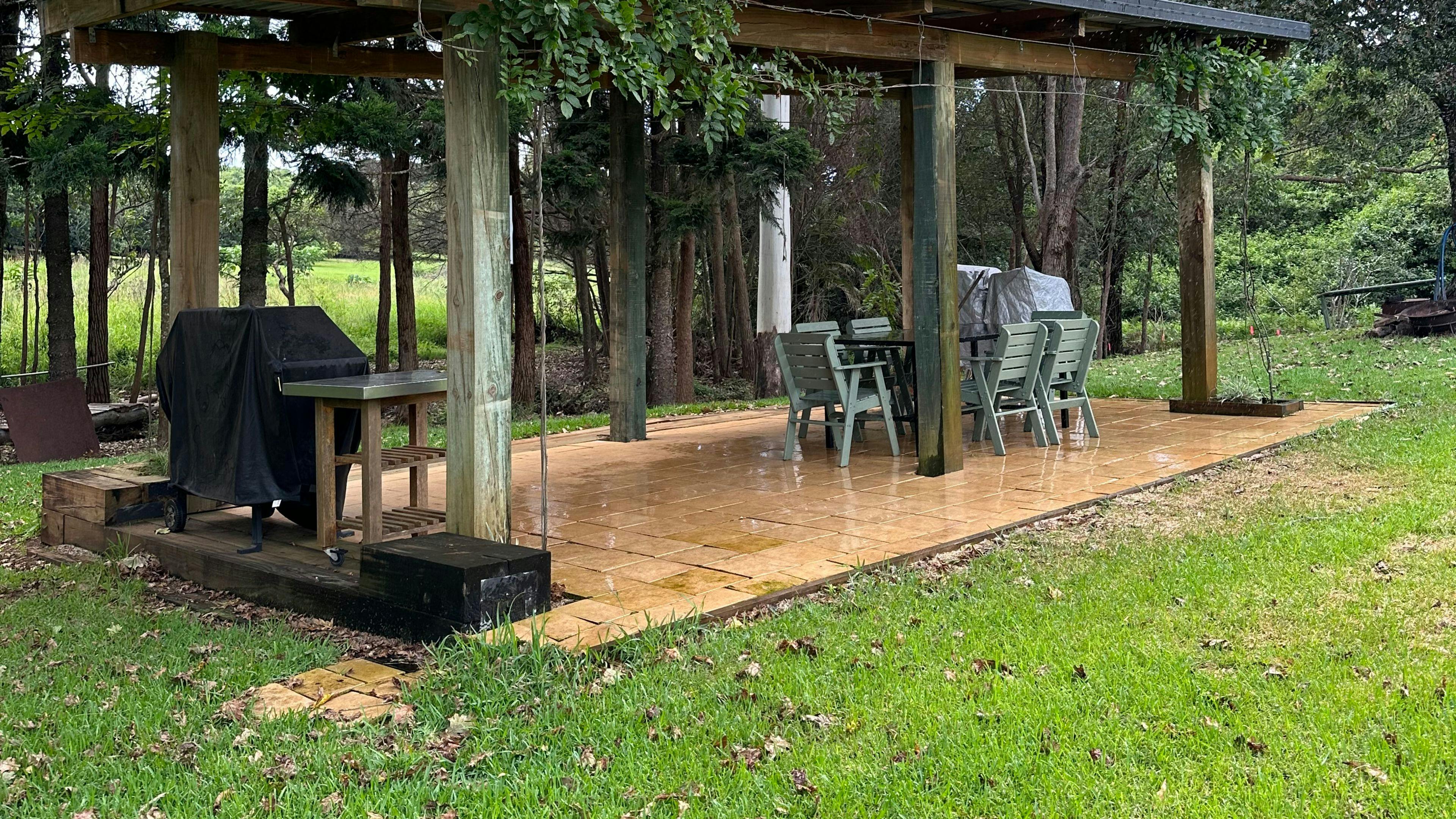 Large covered bbq area with a table and chairs. Also a fire pit for those cold nights.