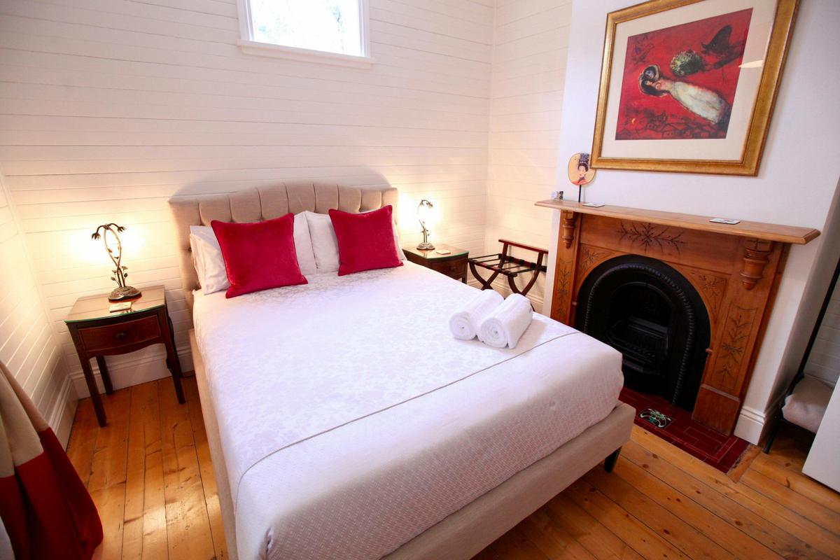 Queen bedroom with original fireplace