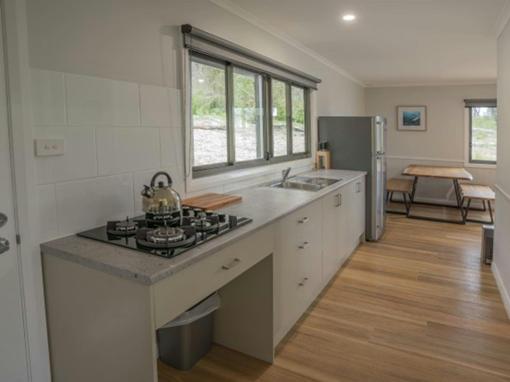 The kitchen and dining table at Pebbly Beach shacks in Murramarang National Park. Photo: John