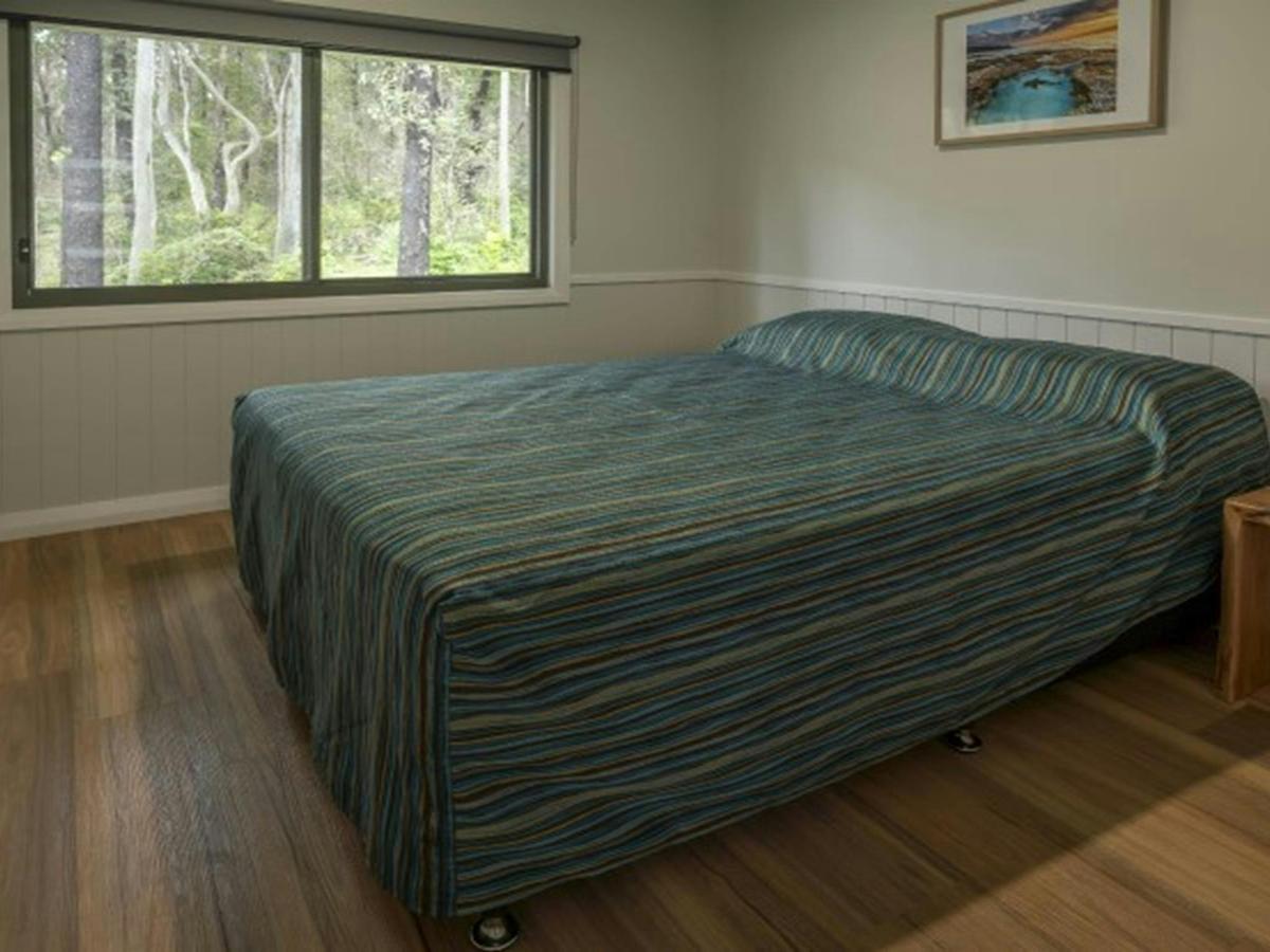 A bedroom with queen bed in Pebbly Beach shacks, Murramarang National Park. Photo: John Spencer