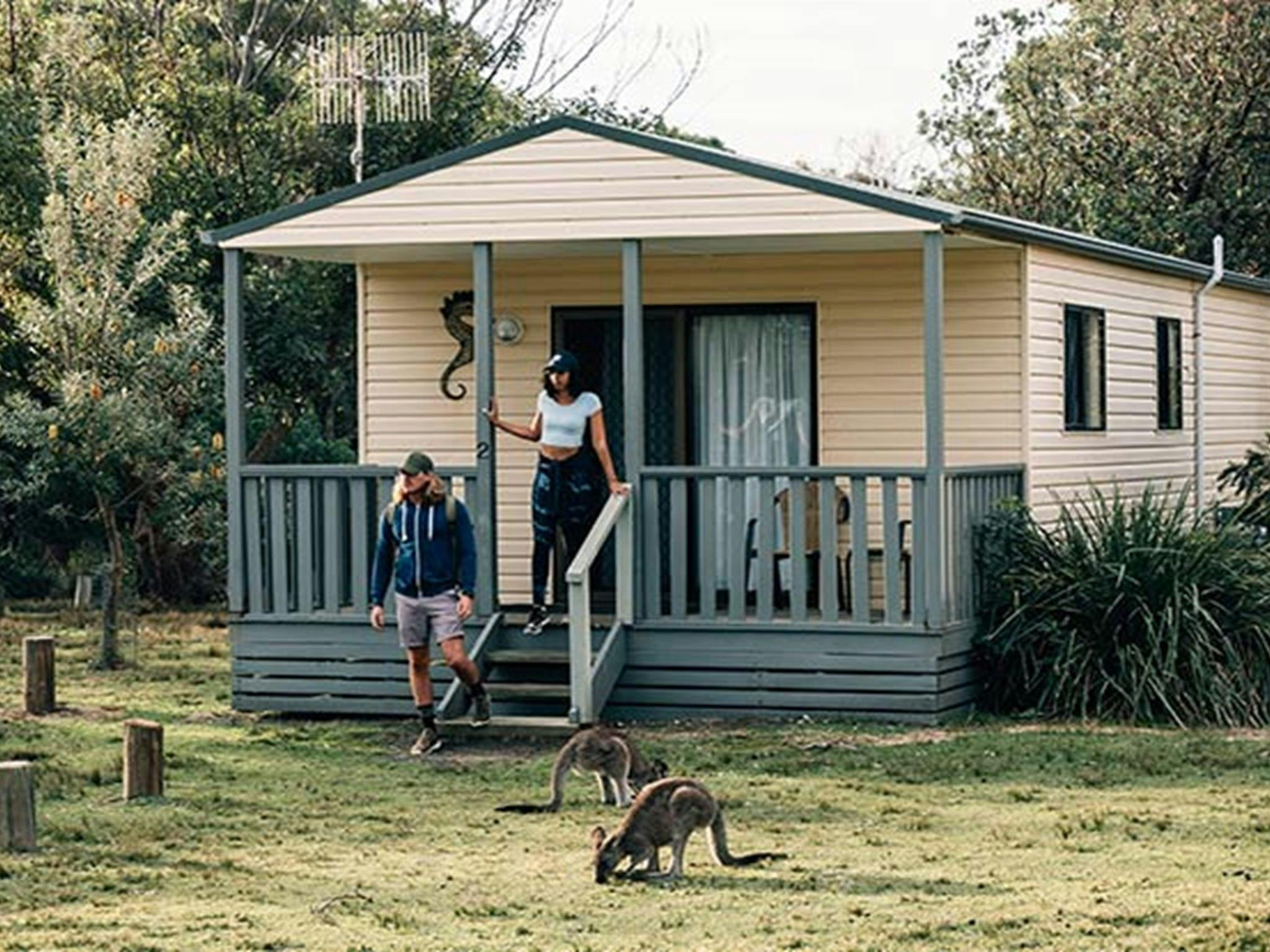 A couple at Pretty Beach cabins, Murramarang National Park. Photo: Melissa Findley/OEH.