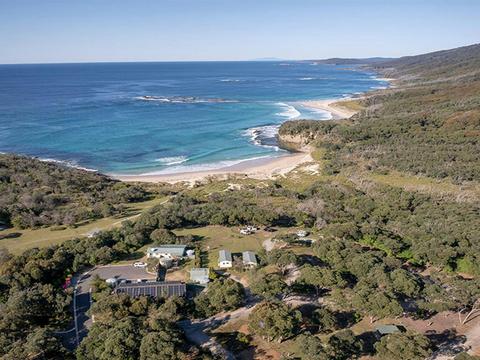Aerial view of Pretty Beach campground and cabins, the ocean in the distance. Credit: John Spencer