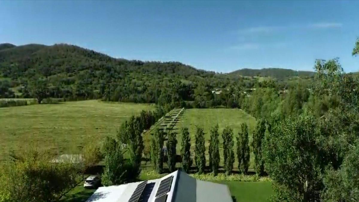 Looking over the stable building and the campsite towards the river and hills in the distance