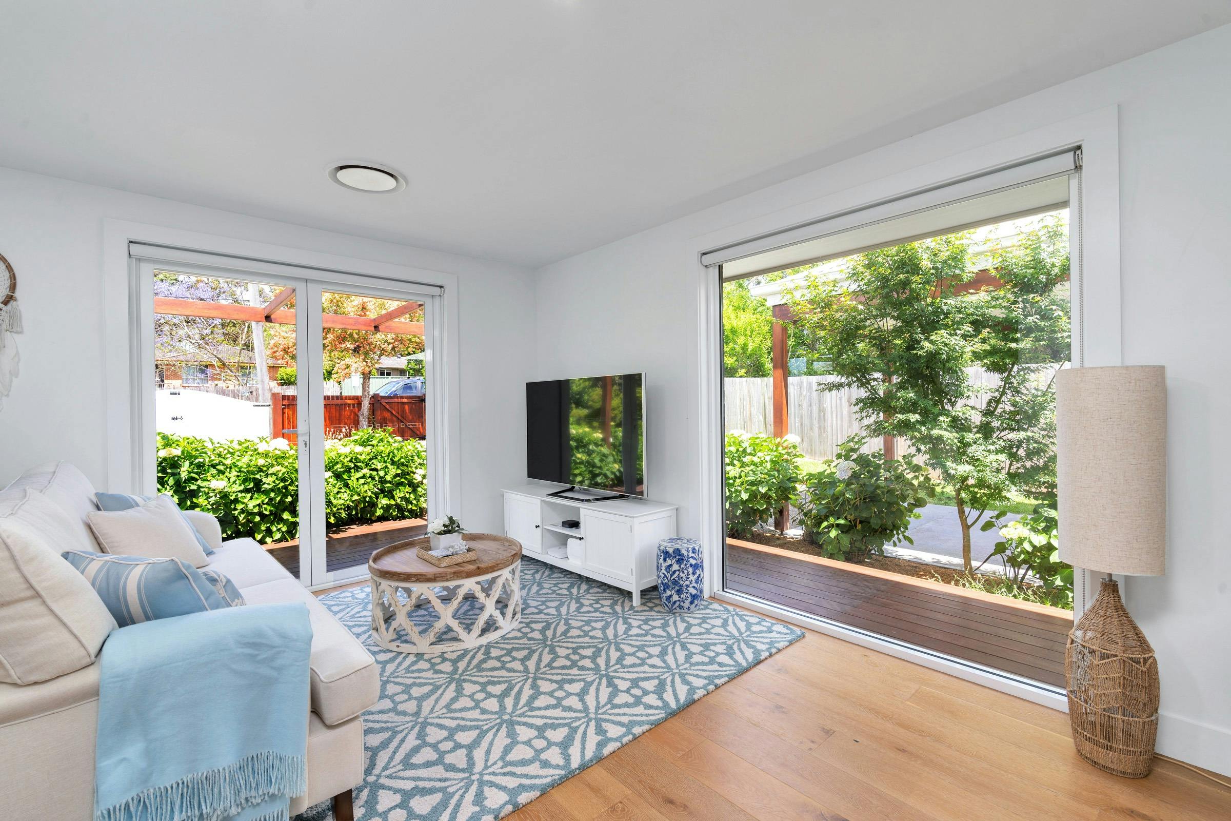 berry accommodation queenberry cottage living room with sofa and large smart TV and coffee table