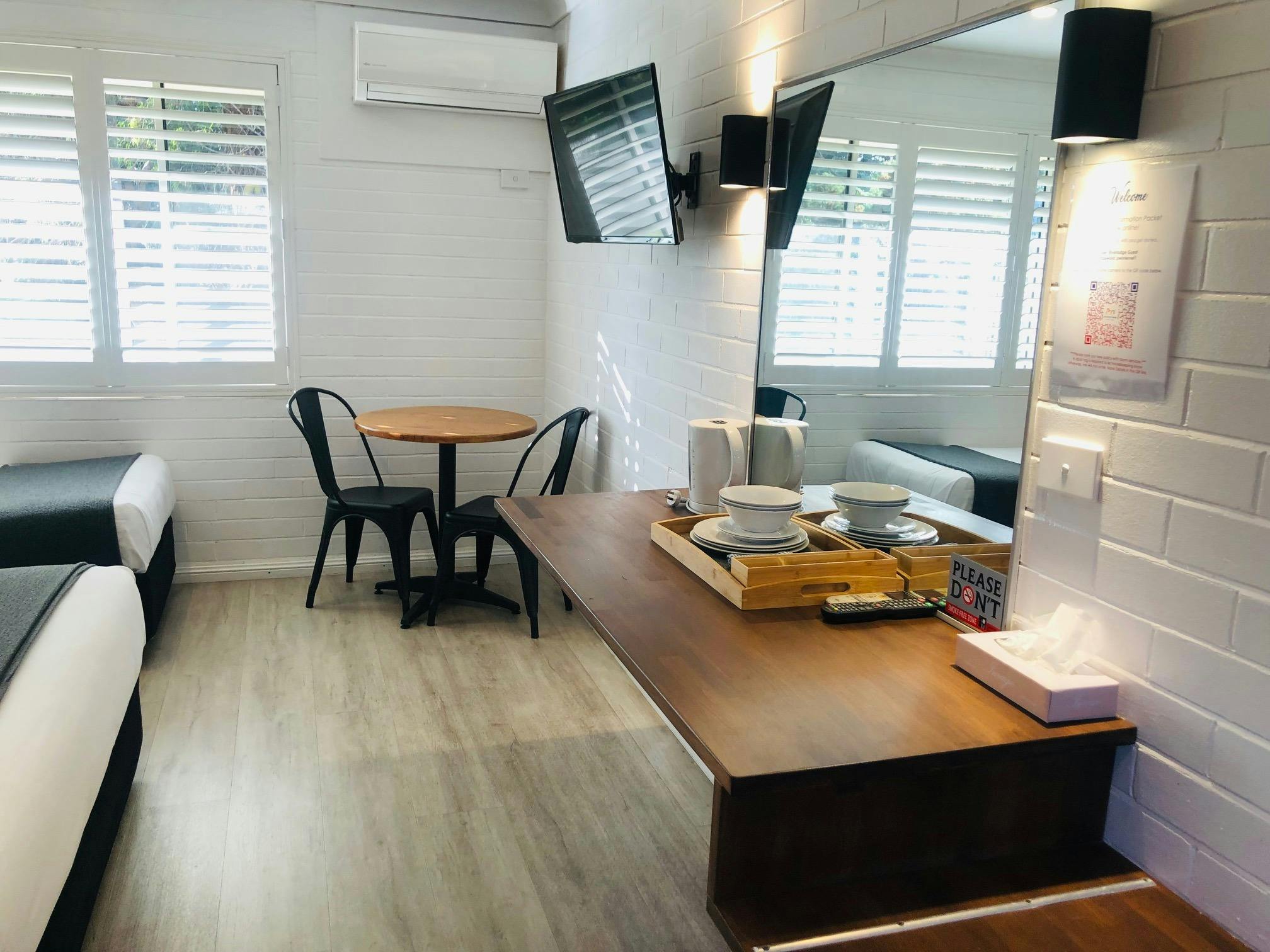 Room Amenities with work table, small dining table with chairs cutlery and crockery