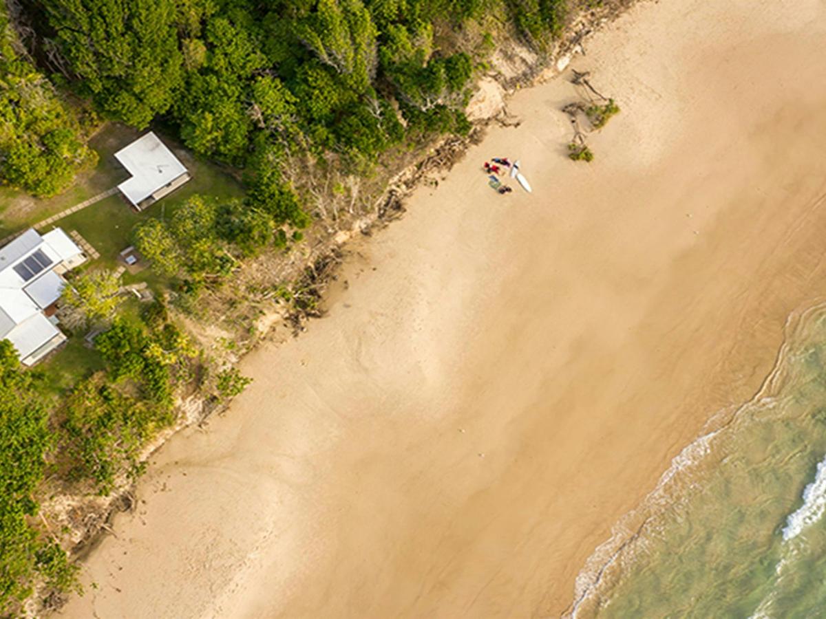 Ariel view of Partridge cottage and Geoffs shed located on Byron Bay beach. Photo: DPIE/John Spencer