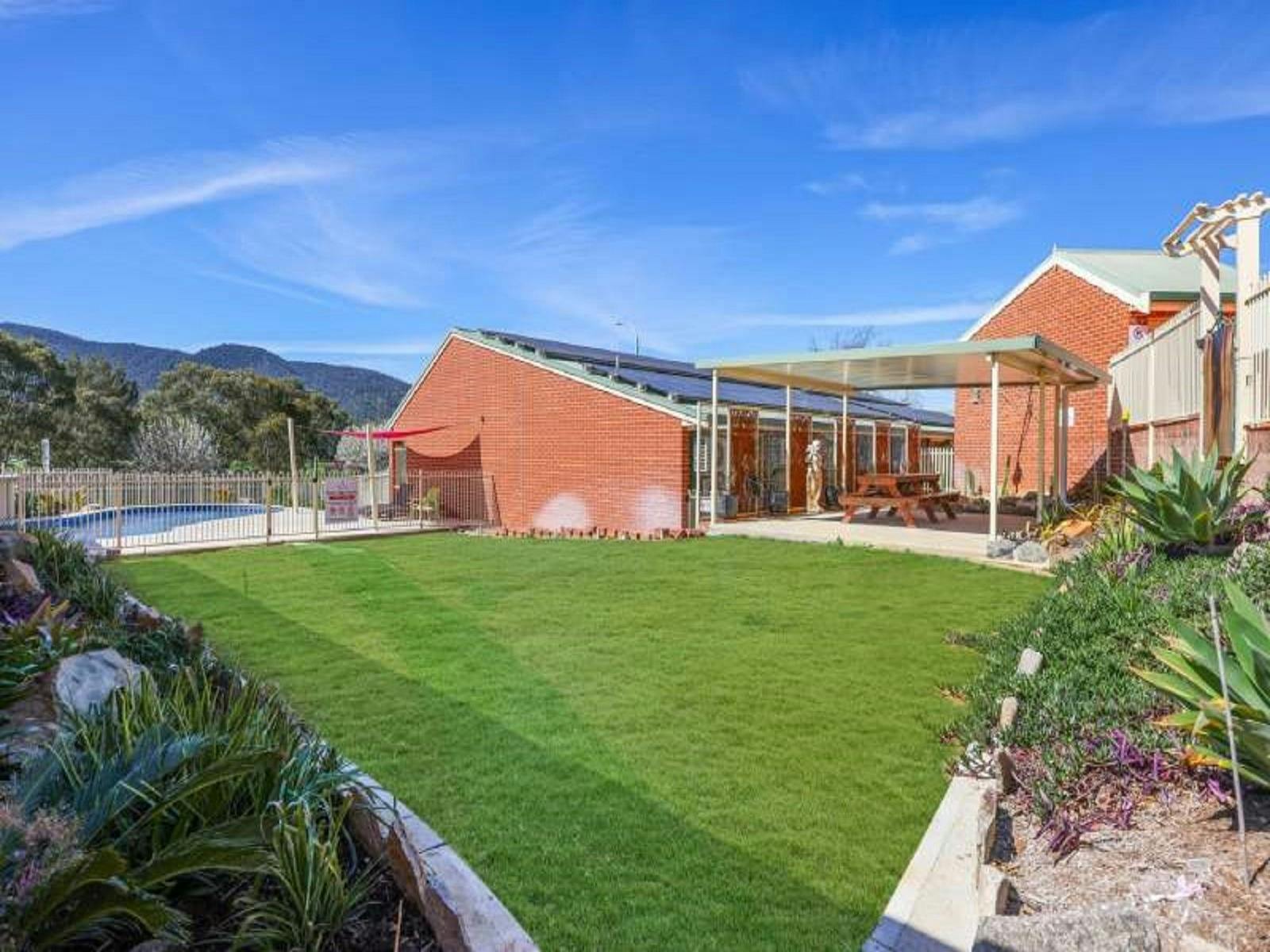 Grass area alongside pool
