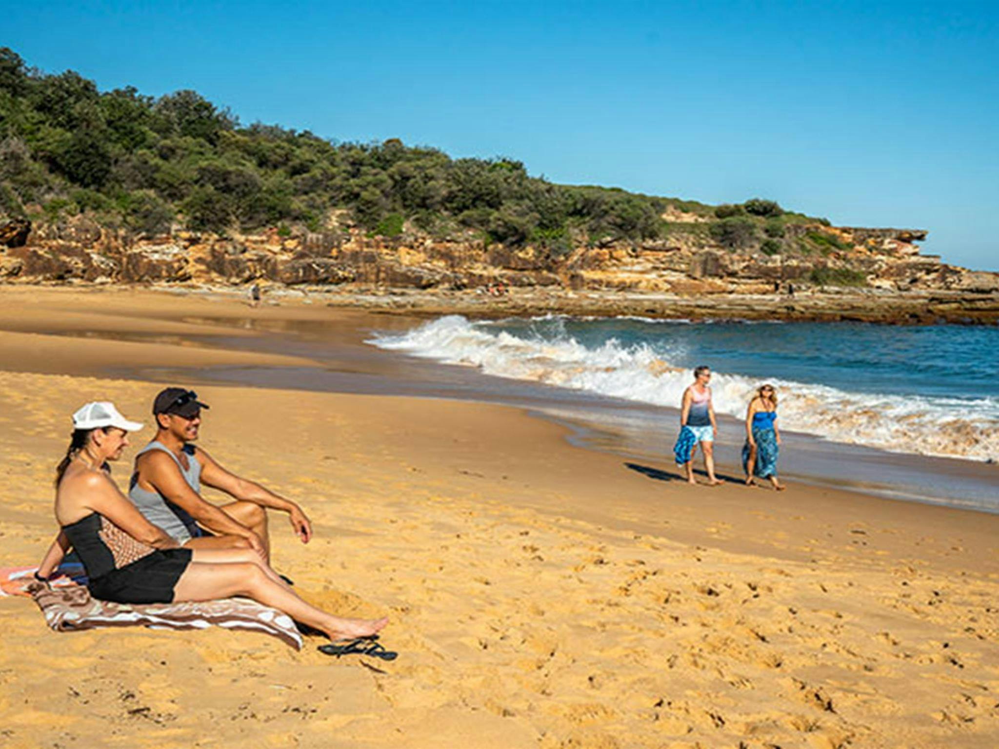 People sunbathing at Putty Beach. Photo: John Spencer/DPIE