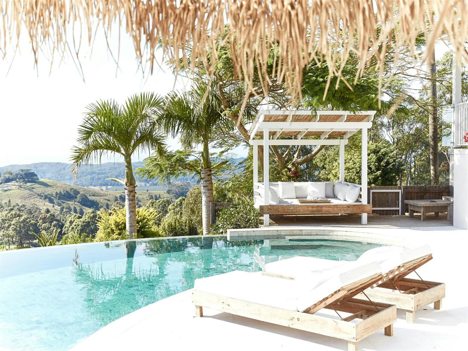 Relaxing pool area with lounge chairs and panoramic views