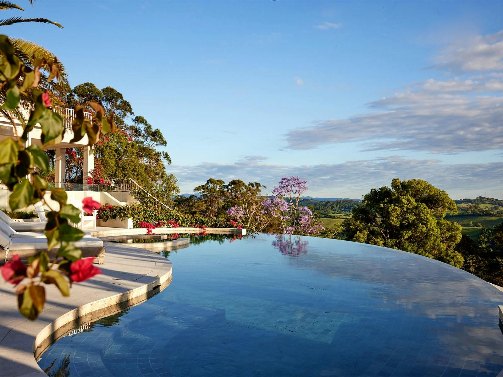 Relaxing pool area with lounge chairs and panoramic mountain views