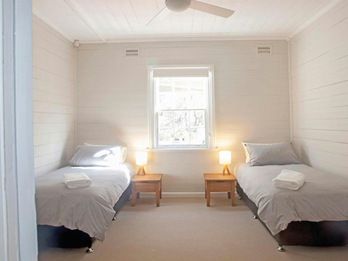 A bedroom with 2 single beds in Reids Flat Cottage, Royal National Park. Photo: Rosie Nicolai/DPIE