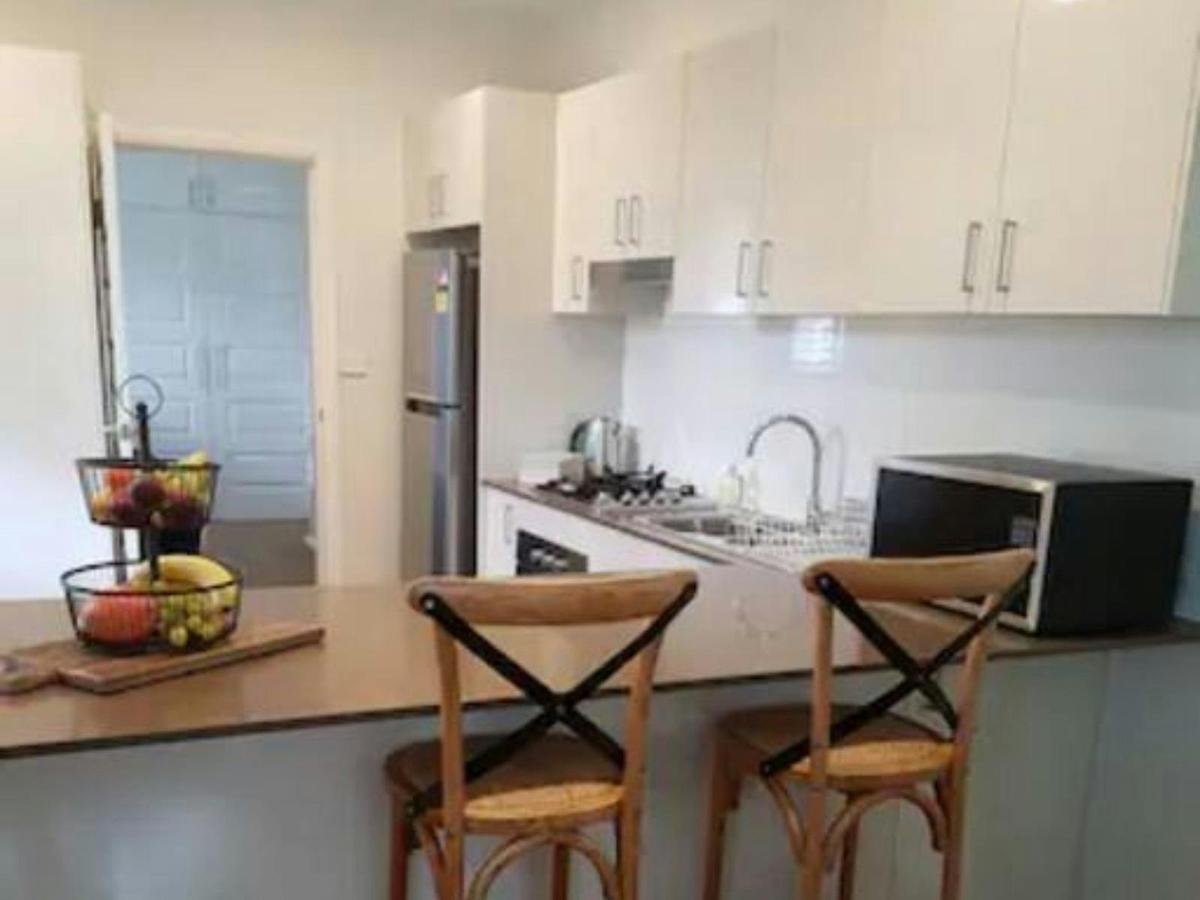 Kitchen with bar stools at the Stylish Sale Street Studio