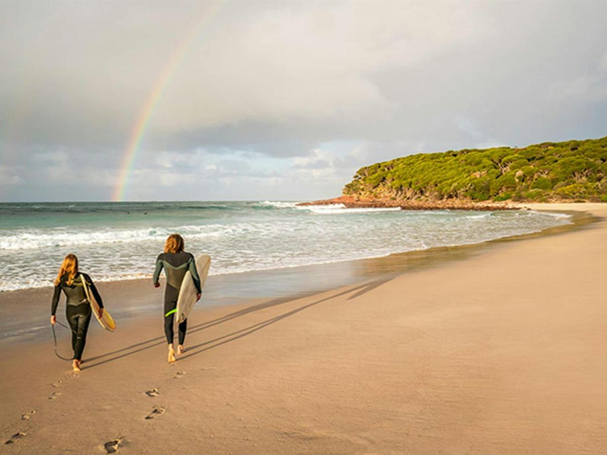 Surfers on the beach at Saltwater Creek campground, Beowa National Park. Photo: John Spencer/OEH