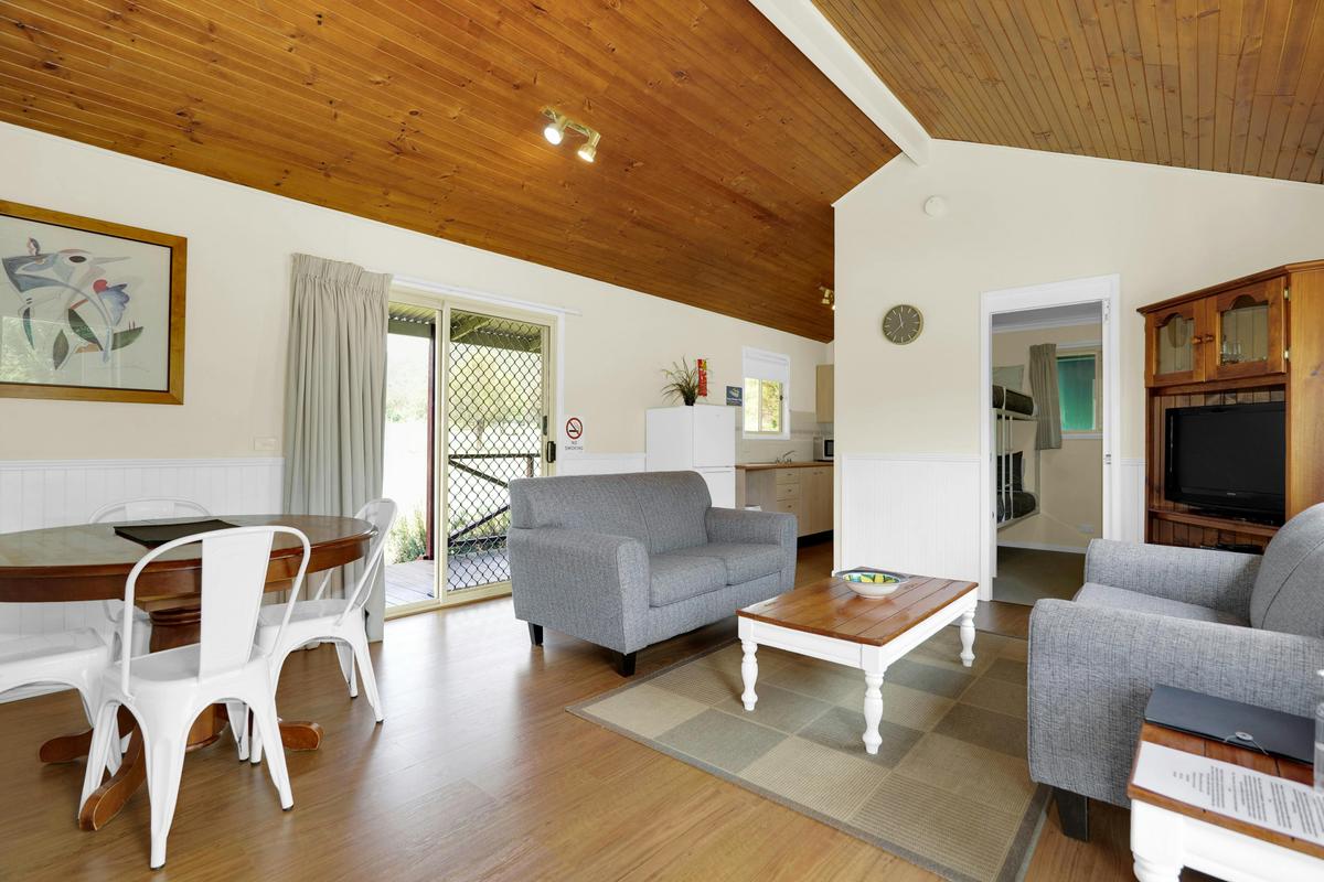 Living room space with comfortable couches with air conditioner & tv with dvd player