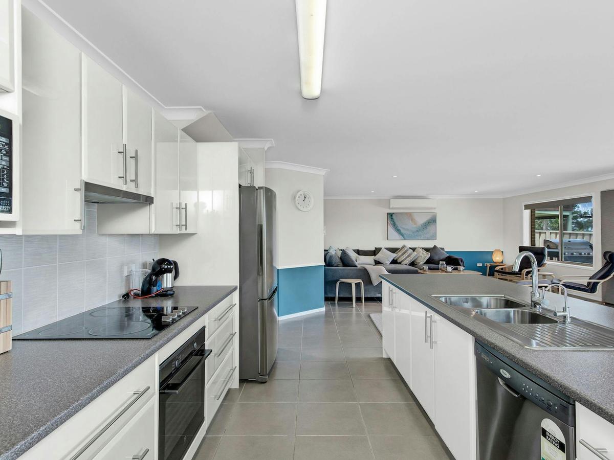 Fully equipped kitchen with dishwasher, microwave, and coffee machine