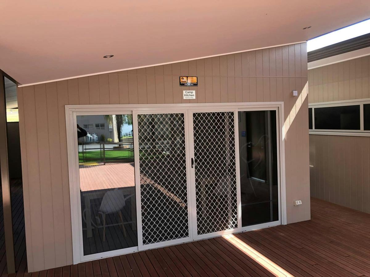 Camp kitchen entrance and shared deck with water views.
