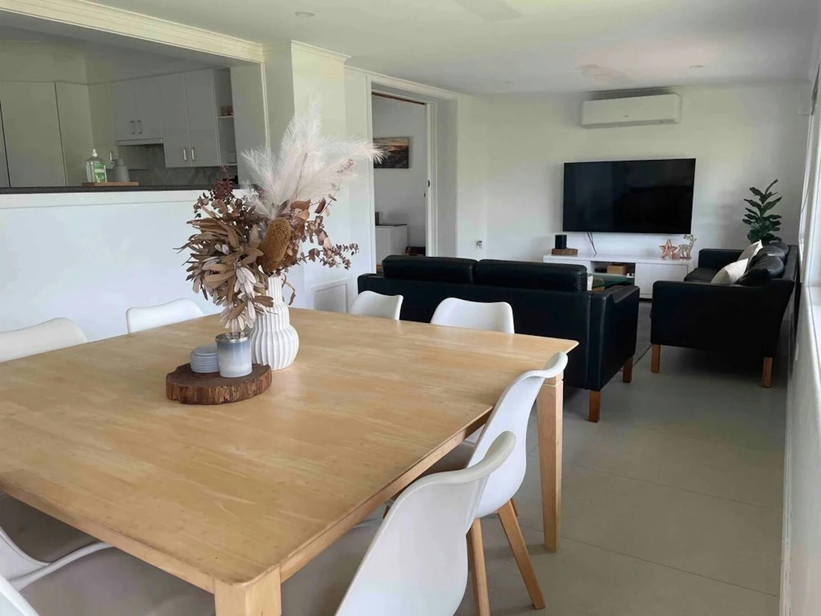 large 8 seater dining table with living room and large flat screen tv