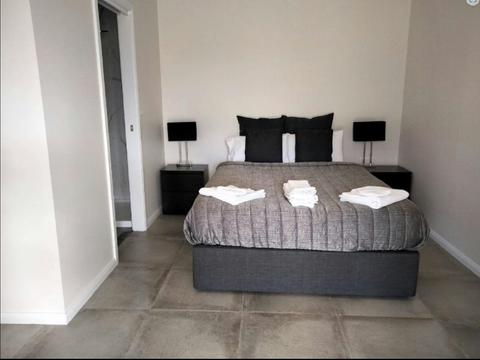 Photo of the bed with entry to the bathroom